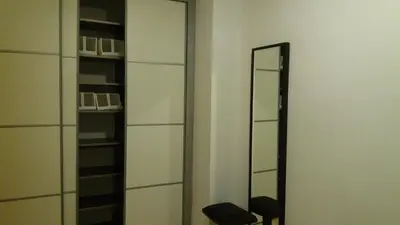 a mirror in a room with a chair and shelves at Apartamento Ciudad de las Ciencias in Valencia