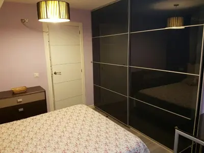 a bedroom with a bed and a large glass closet at Balandra Flat in Valencia