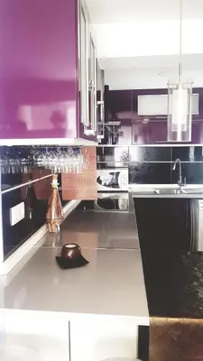 a kitchen with purple and black cabinets and a sink at Balandra Flat in Valencia