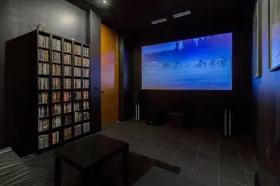 a library with a large screen and a large tv at VLVilla - Villa de lujo en Valencia con piscina privada y sala de cine in Burjasot