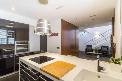 a kitchen with a sink and a stove top oven at VLVilla - Villa de lujo en Valencia con piscina privada y sala de cine in Burjasot
