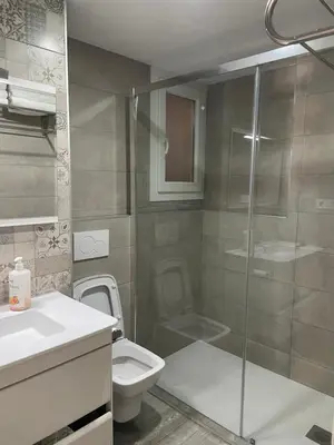 a bathroom with a toilet and a glass shower at Apartment near Arts & Science in Valencia