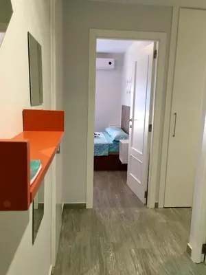 a room with a bedroom with a bed and a desk at Apartment near Arts & Science in Valencia