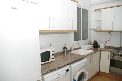 a kitchen with a sink and a microwave at Carlos & Ana Amplio Apartamento 4 Habitaciones Centro Valencia in Valencia