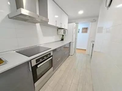a kitchen with a sink and a stove top oven at Céntrico apartamento en Valencia próximo parada de metro Ángel Guimerà in Valencia