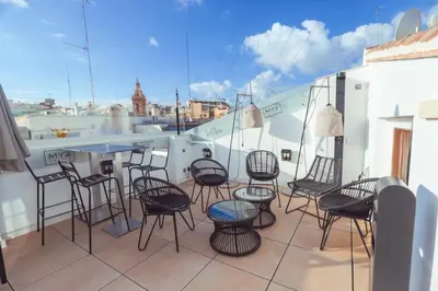 a group of chairs and tables on a balcony at MYR Marqués House in Valencia
