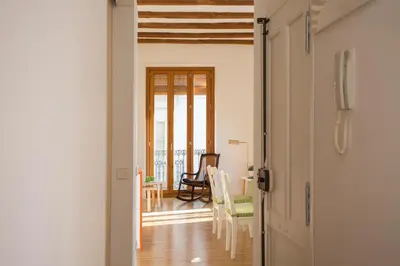 a hallway with a room with a table and chairs at Balcón de Manet in Valencia