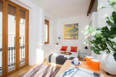 a living room with a couch and a table at Balcón de Manet in Valencia