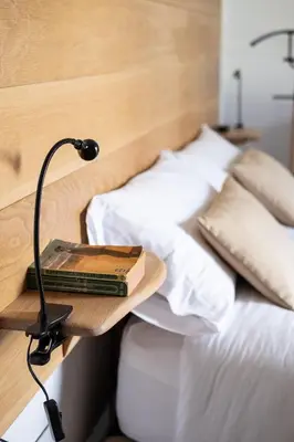 a book on a shelf on a bed with pillows at Barracart Apartments in Valencia