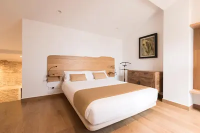 a bedroom with a large bed with a wooden headboard at Barracart Apartments in Valencia