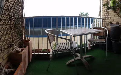 a table and two chairs on a balcony at Piso Playa Patacona/Malvarrosa in Valencia