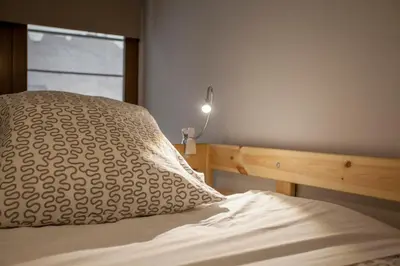a bedroom with a bed with a pillow and a lamp at Apartamento Alta in Valencia
