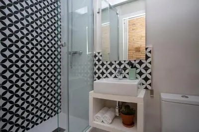 a bathroom with a shower and a sink and a mirror at SingularStays Ático Roger de Flor in Valencia