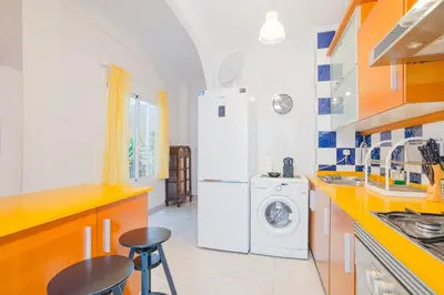 a kitchen with a refrigerator and a washer and dryer at Cisneros flat in Valencia