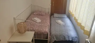 a small room with a bed and a table at Cisneros flat in Valencia
