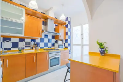 a kitchen with wooden cabinets and a stove top oven at Cisneros flat in Valencia