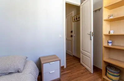 a bedroom with a bed and a table and a closet at Apartment City of Arts and Sciences 2 in Valencia