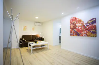 a living room with a couch and a painting on the wall at El Micalet Apartment in Valencia
