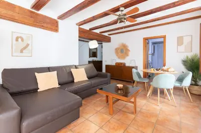 a living room with a couch and a table at Travel Habitat Plaza del Pilar. in Valencia
