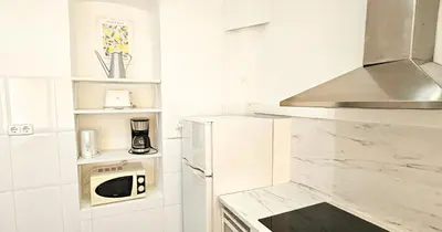 a white kitchen with white appliances and a microwave at Your home in Valencia in Valencia
