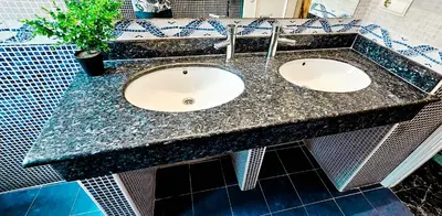 a bathroom with three sinks and a potted plant at Your home in Valencia in Valencia