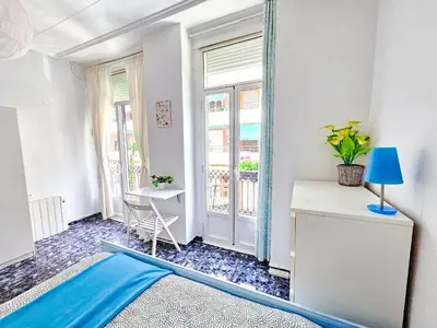 a room with a mirror and a table and a window at Your home in Valencia in Valencia