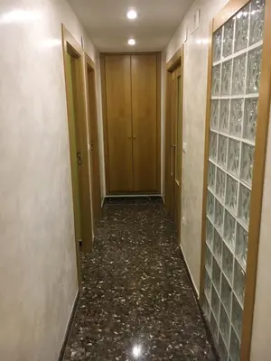 a hallway of a hotel with glass doors and a hallwayngth at Apartament Magnífico in Paiporta
