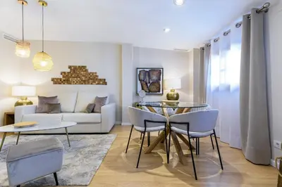 a living room with a table and chairs and a couch at TTdSSa VLC Ramellets Street Central Market in Valencia