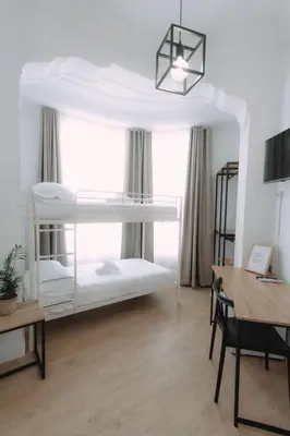a room with two bunk beds and a desk at Concept Rooms in Valencia