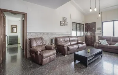 a living room with leather furniture and a table at Nice Home In Alberique in Alberique
