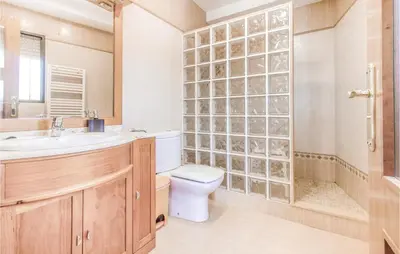 a bathroom with a toilet and a shower and a sink at Nice Home In Alberique in Alberique