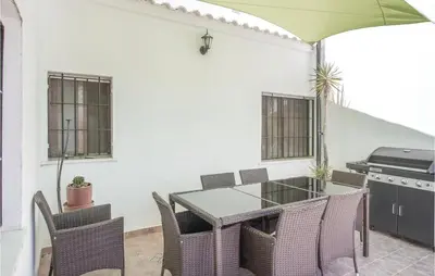 a patio with a table and chairs and a grill at Nice Home In Alberique in Alberique