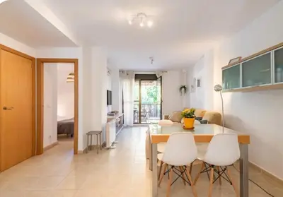 a kitchen and living room with a table and chairs at Casa Dora Puzol playa in Puzol
