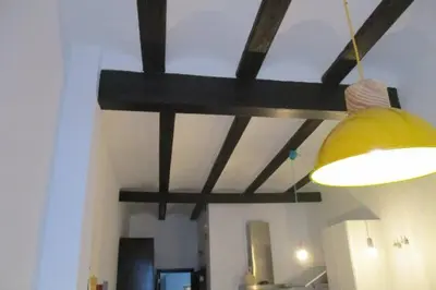 a yellow light hanging from a ceiling in a room at Cozy fisherman's house in Valencia