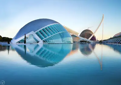 a large building sitting on top of a body of water at Versus Apartments near City of Arts in Valencia