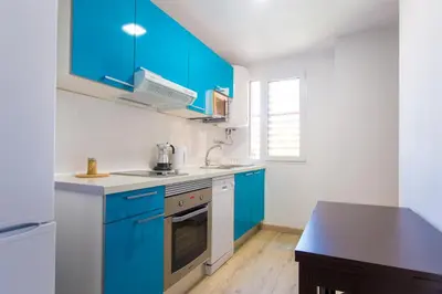 a kitchen with blue cabinets and a sink at Versus Apartments near City of Arts in Valencia