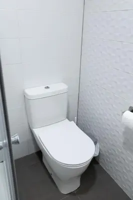 a bathroom with a white toilet in a stall at Up Town in Valencia