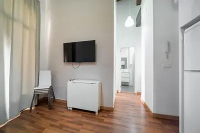 a living room with a tv on a white wall at Up Town in Valencia