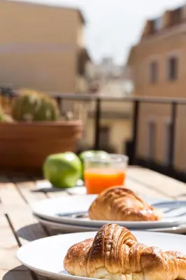 two plates of croissants and orange juice on a table at Apartments Downtown Valencia in Valencia
