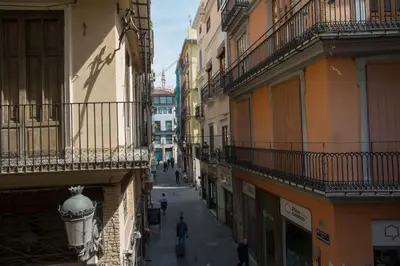 an alley with people walking down a street between buildings at Apartment Collado in Valencia