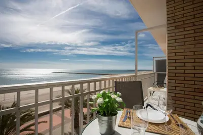 a balcony with a table and a view of the beach at SingularStays El Faro in Puzol
