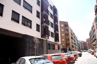 a row of cars parked on a city street at Apartamento Ribes Valencia in Valencia