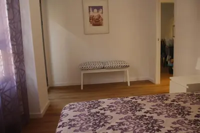 a room with a bed and a bench in it at Apartamento Ribes Valencia in Valencia