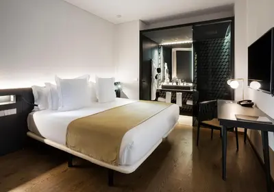 a hotel room with a large bed and a desk at One Shot Mercat in Valencia