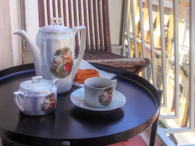 a table with a tea pot and cups on a balcony at Valencian Apartment in Valencia