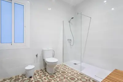 a bathroom with a toilet and a glass shower at Total Valencia Vintage in Valencia