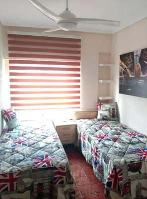 a bedroom with two twin beds and a window at Malvarosa Beach Family in Valencia