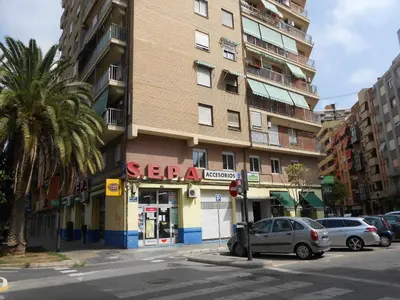 a building on a street with cars parked in front at Apartment in Valencia in Valencia
