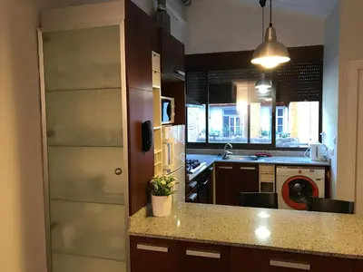 a kitchen with a counter top and a stove top oven at Atico En El Centro in Valencia