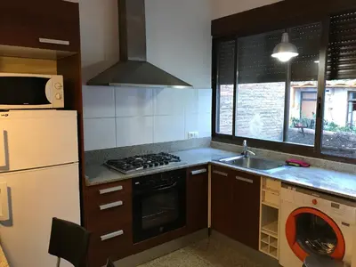 a kitchen with a sink and a stove top oven at Atico En El Centro in Valencia